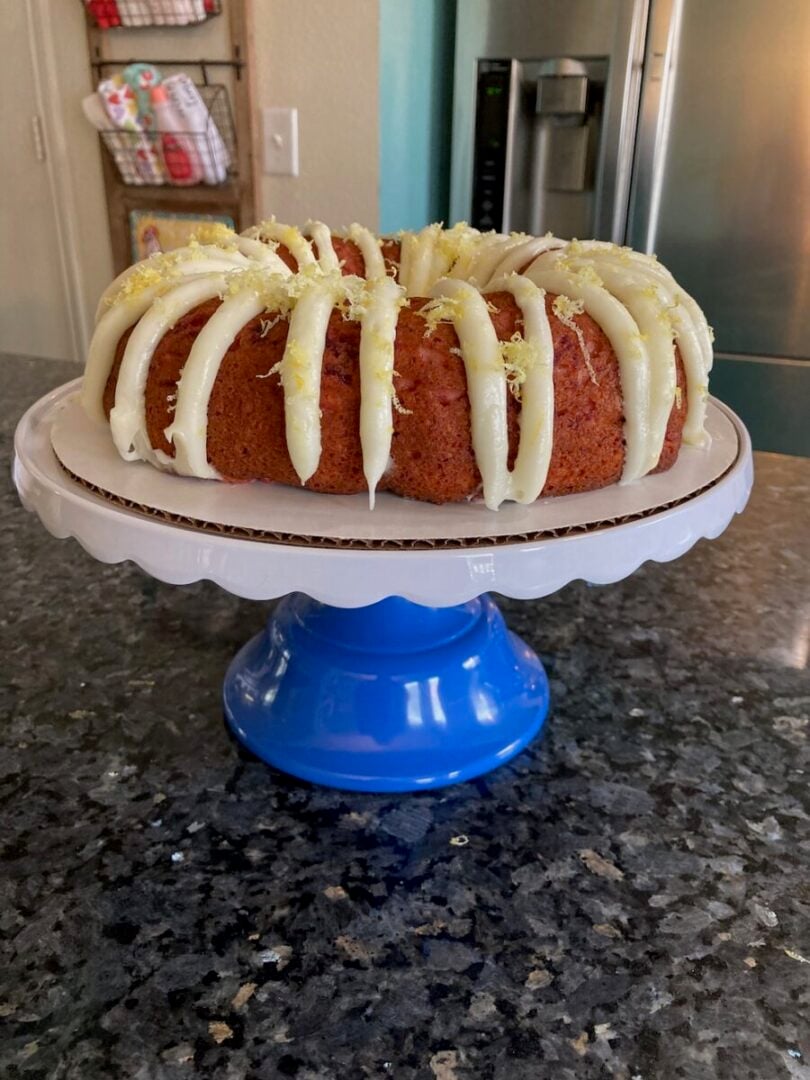 bundt cake with frosting on stand