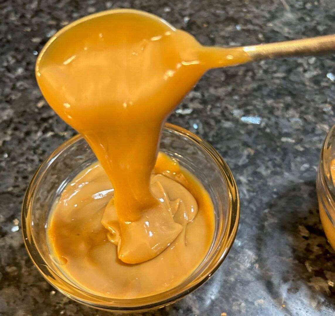 Smooth and creamy caramel being poured into a bowl