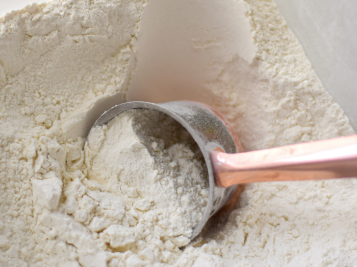 flour in bin with measuring cup