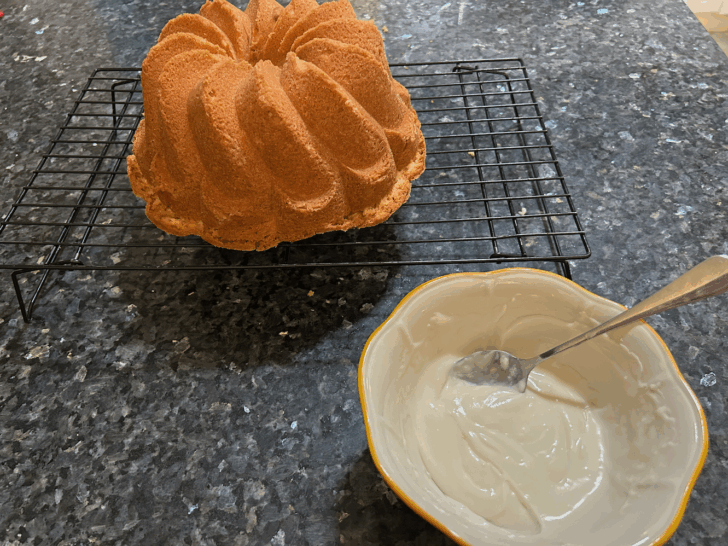 pound cake with bowl of glaze nearby