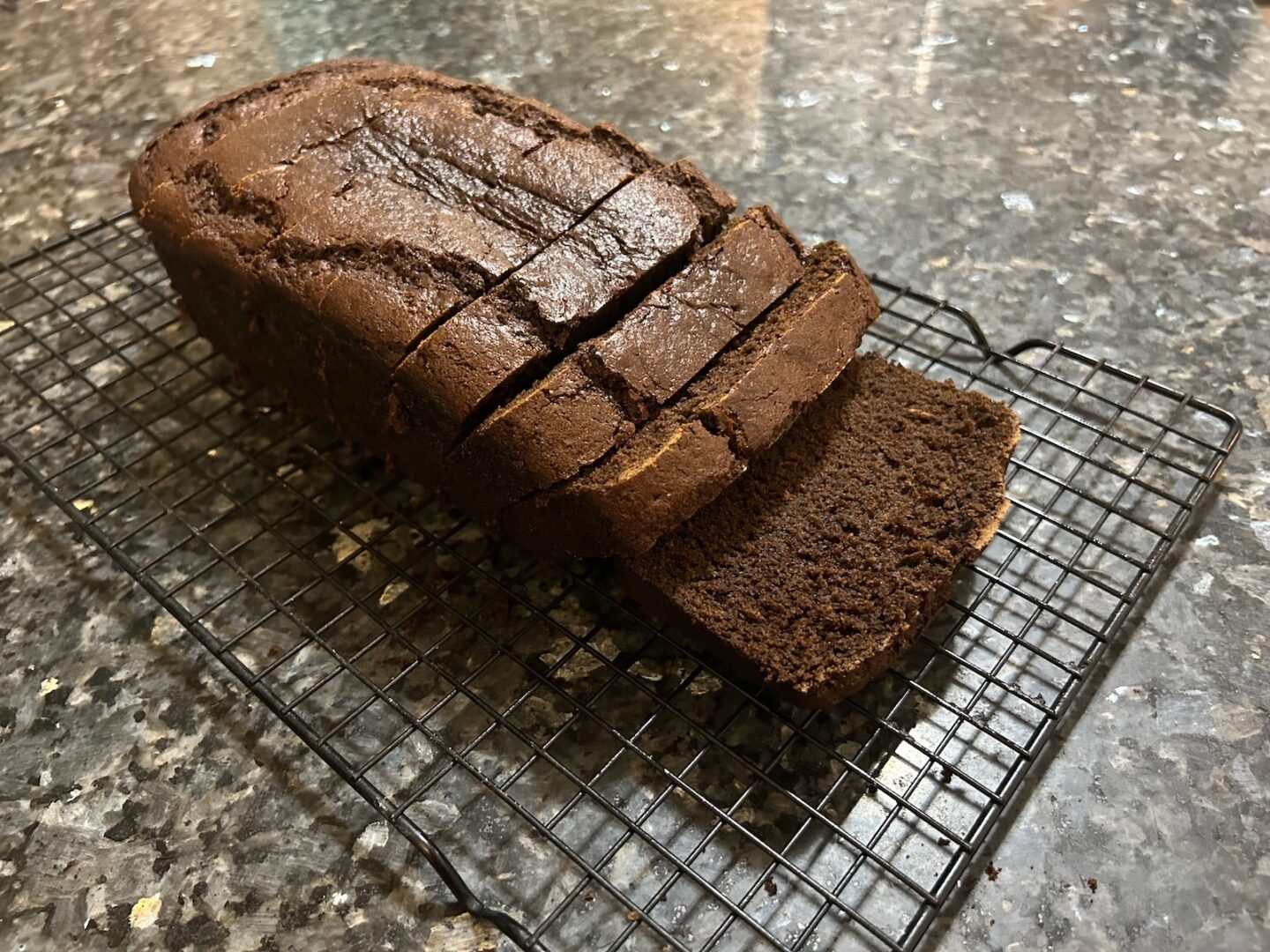 Gingerbread loaf sliced, cooling on wire rack