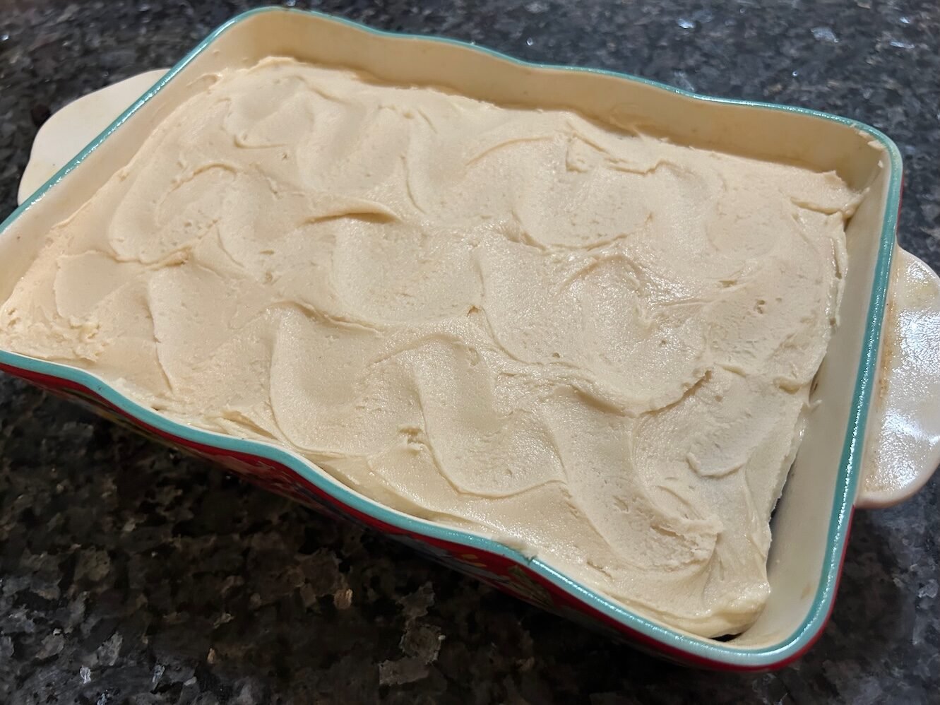 frosted cake in rectangular dish