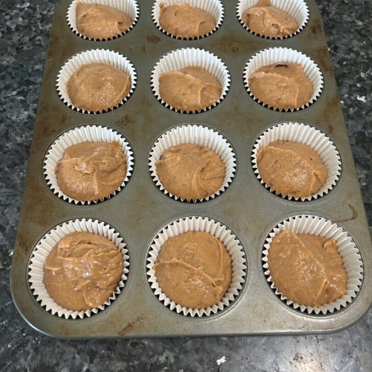 Pumpkin Spice Cupcake batter in muffin tin with liners