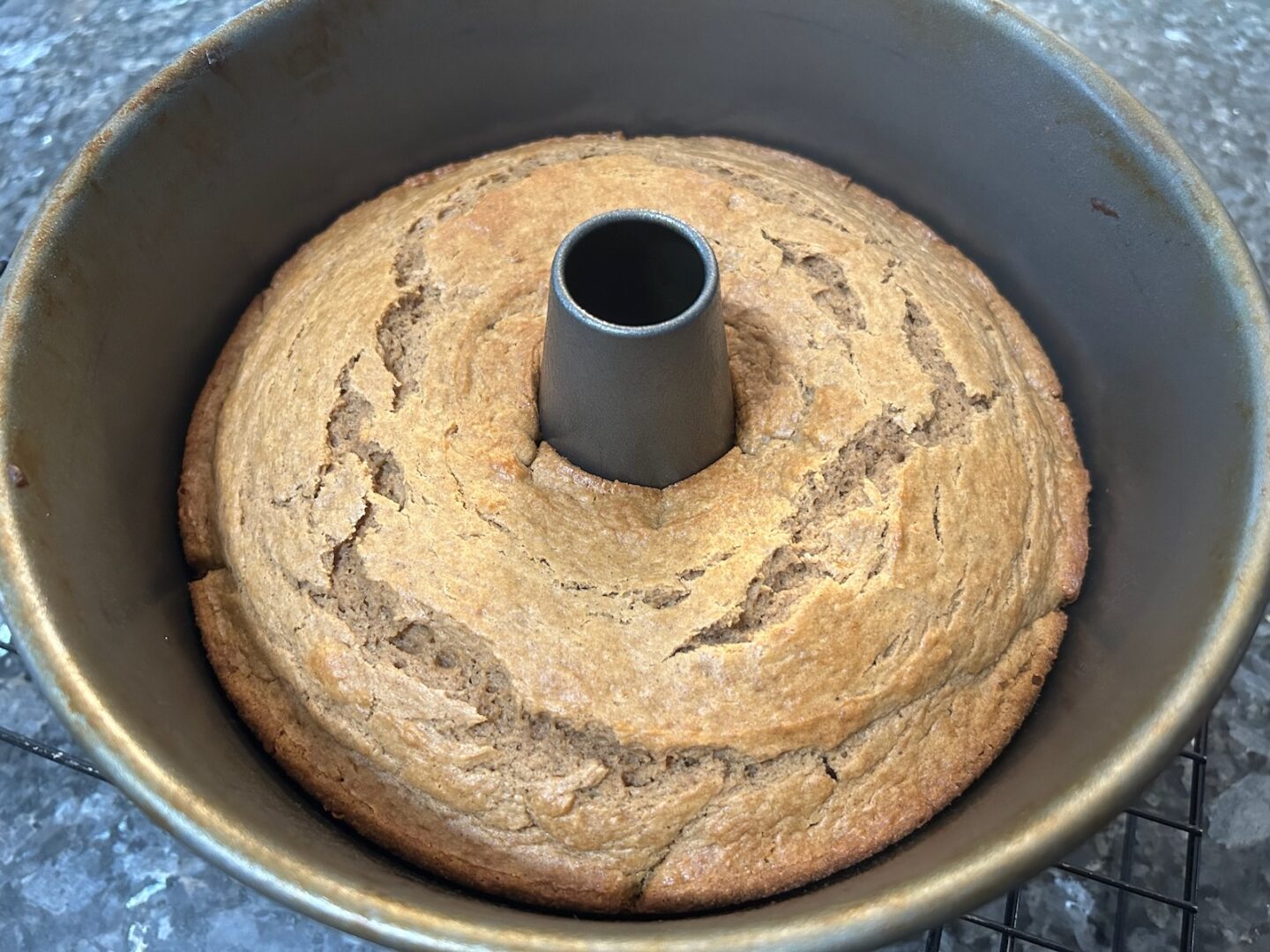 tube pan with baked pumpkin cake inside