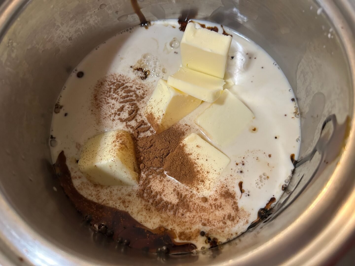 butter, sugar, molasses, milk in pan on stove