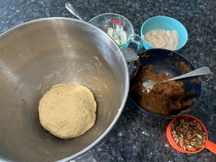 pumpkin spice cinnamon rolls ingredients on counter (dough in bowl)