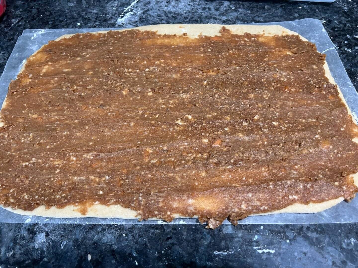 pumpkin mixture spread on dough to make cinnamon rolls