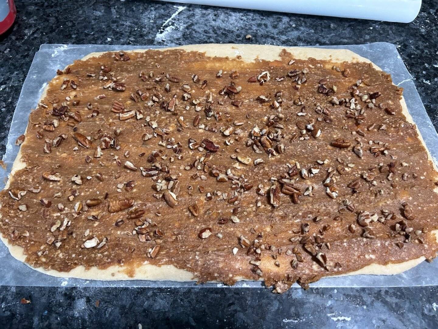 adding pecans to cinnamon rolls