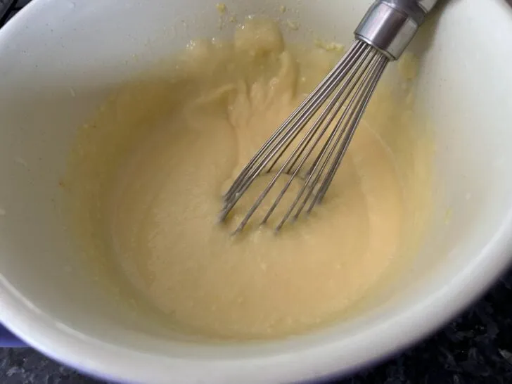 vanilla pudding in bowl with whisk