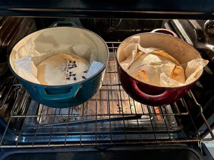 two sourdough loaves in oven (in separate dutch ovens)