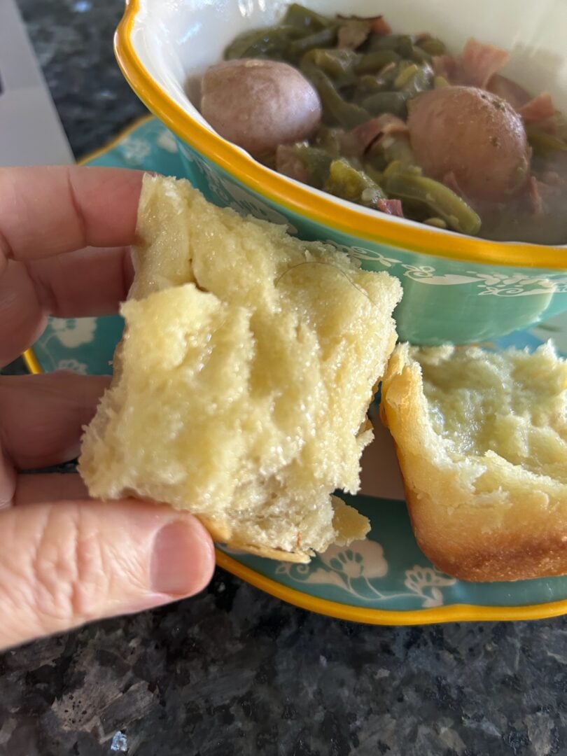 interior of fluffy dinner roll, slathered in melted butter