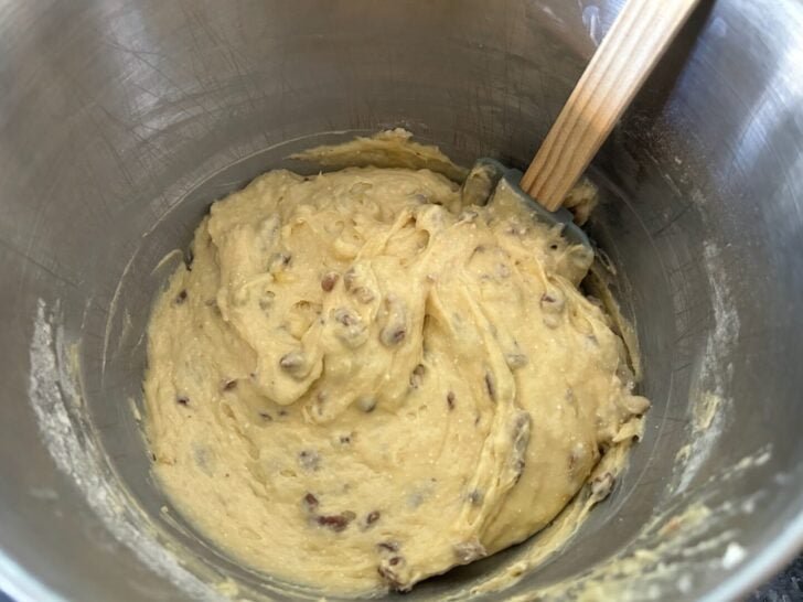 banana bread batter, pecans added, in mixing bowl