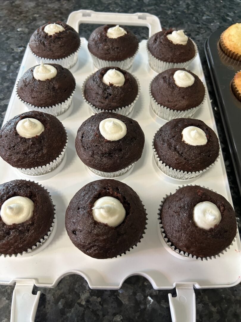 hot cocoa cupcakes with marshmallow fluff frosting piped inside