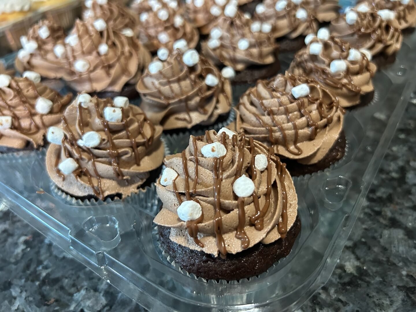 hot cocoa cupcakes, fully decorated with ganache and marshmallows