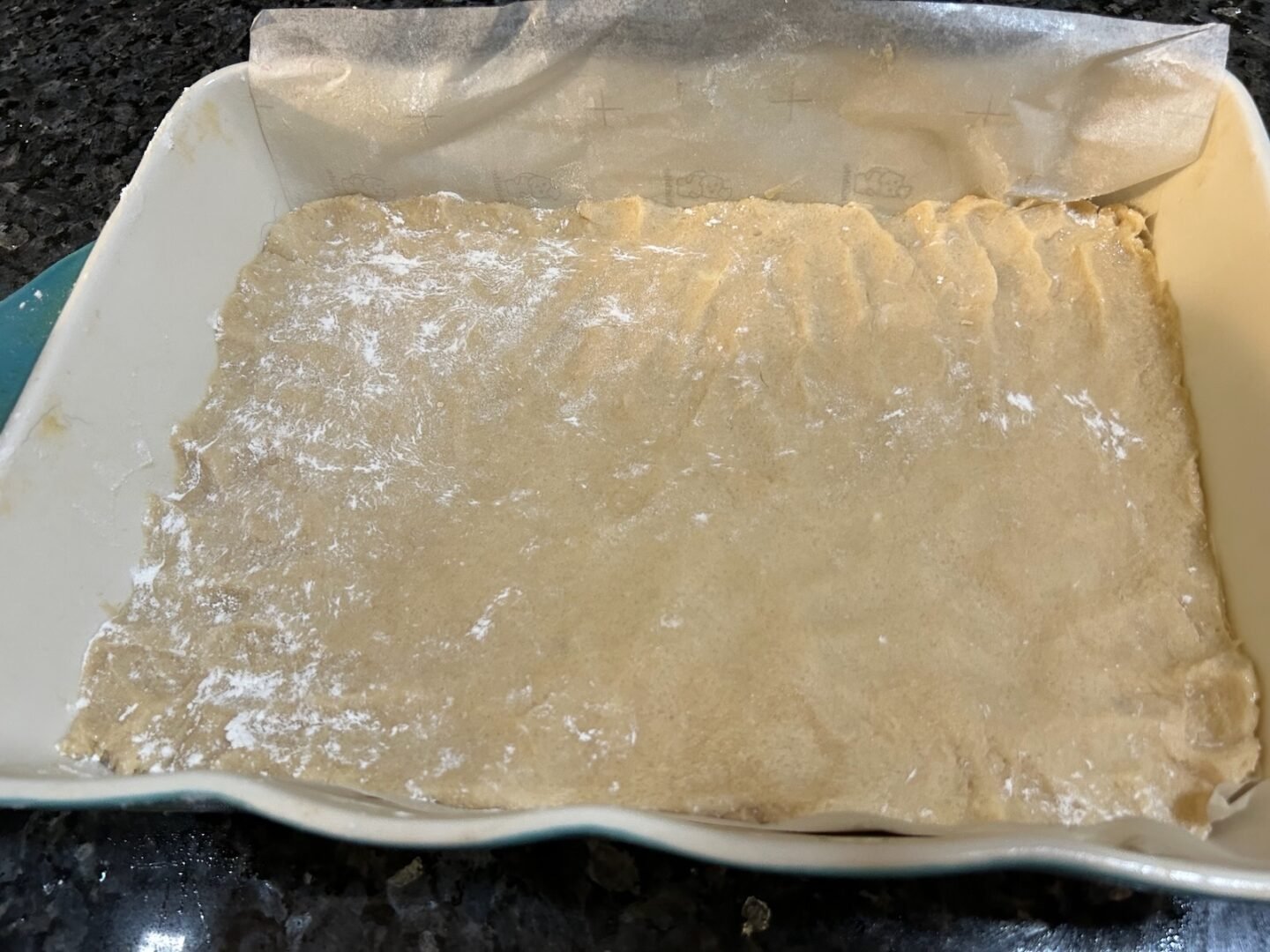 Peppermint Bark Cookie Bar crust in baking dish