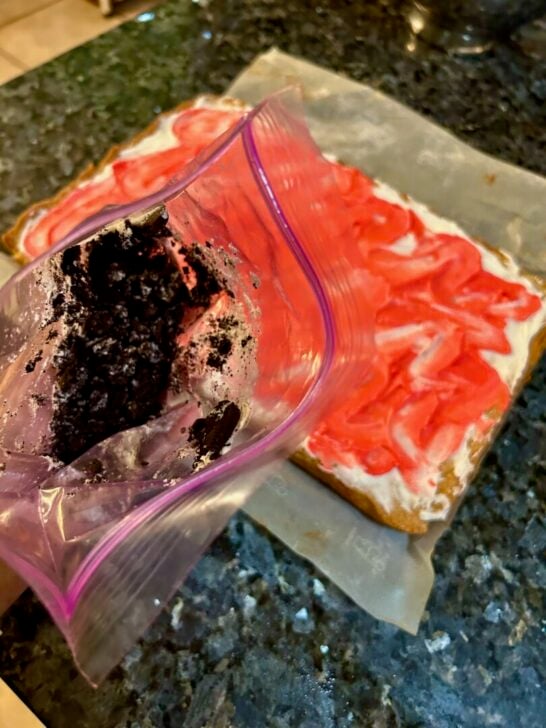 crushed Oreos in bag next to iced cookie bars