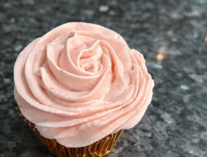 Stabilized Whipped Cream frosting on cupcake, swirled in pretty shade of soft pink