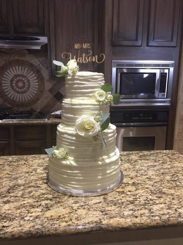 elegant four tiered cake with white roses