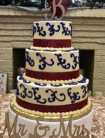bright colored scrolling on white wedding cake