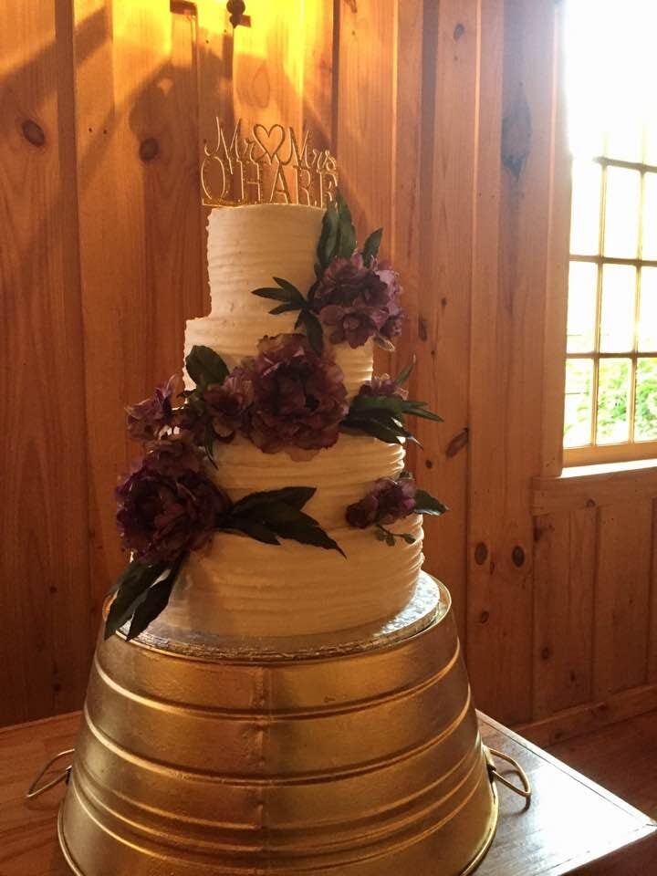 southern wedding cake with flowers on upside-down barrel