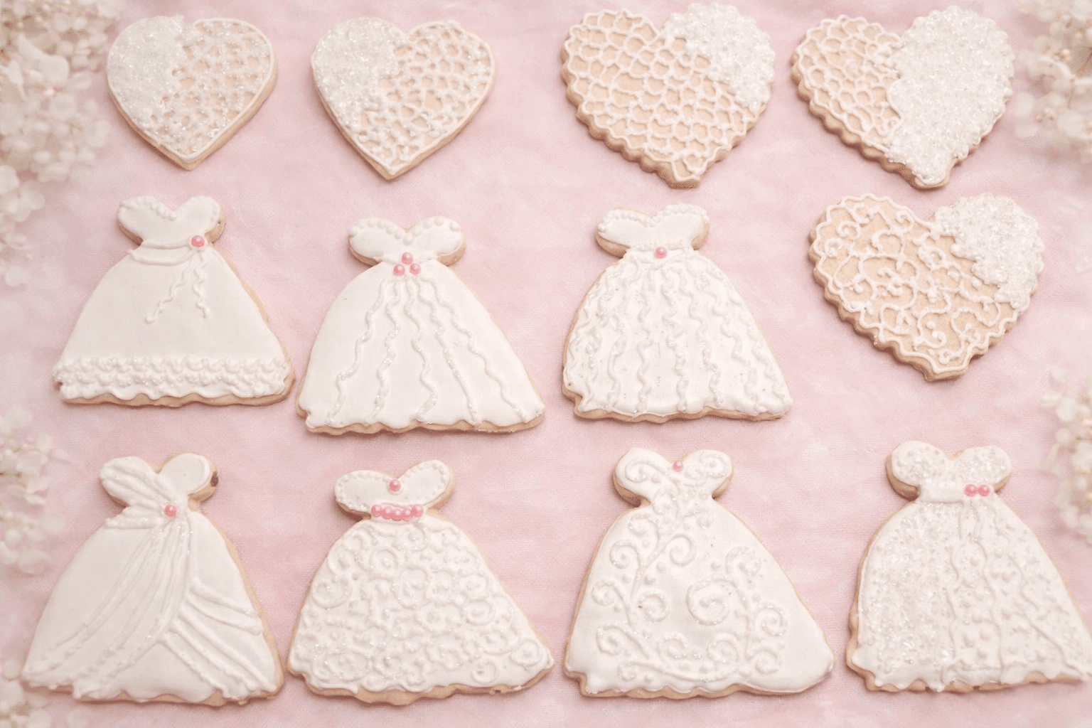 beautiful white wedding cookies shaped like wedding dresses and hearts