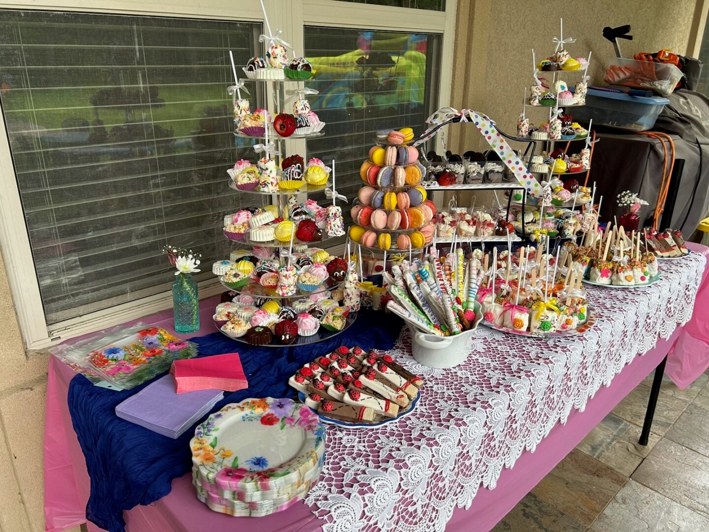 graduation dessert table with chocolate covered goodies and other treats on tiered stands.