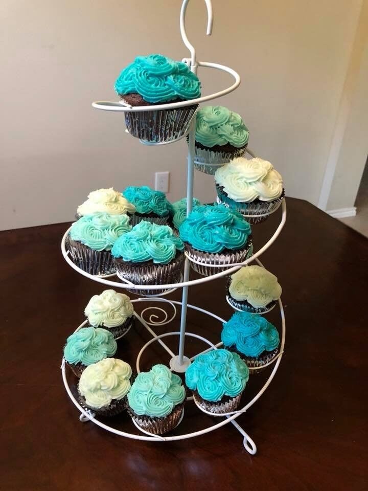 teal and white frosted cupcakes on stand