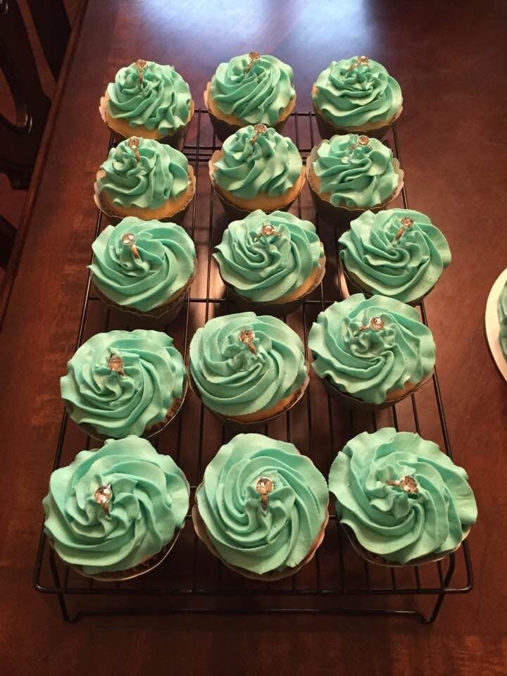 soft teal rosettes on cupcakes for baby shower