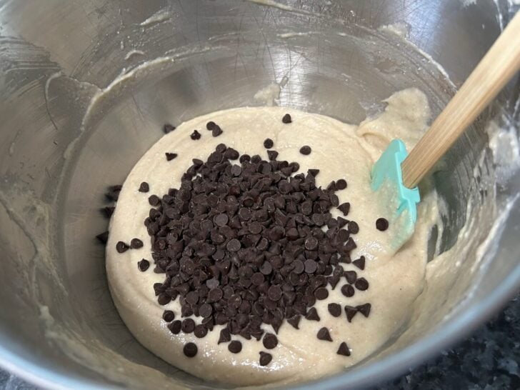 cannoli cupcake batter in bowl with chocolate chips added