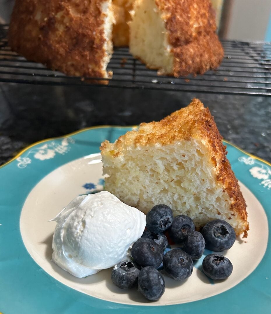 slice of angel food cake with whipped cream and berries