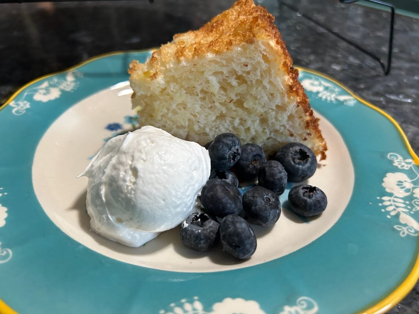 2-Ingredient Angel Food Cake on plate with whipped cream and berries