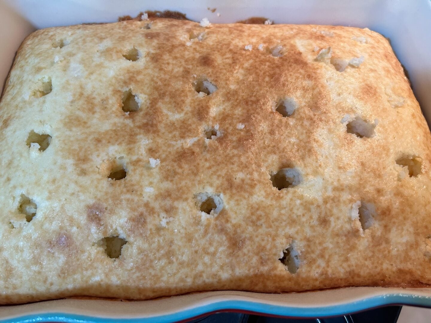 baked cake with holes poked in it
