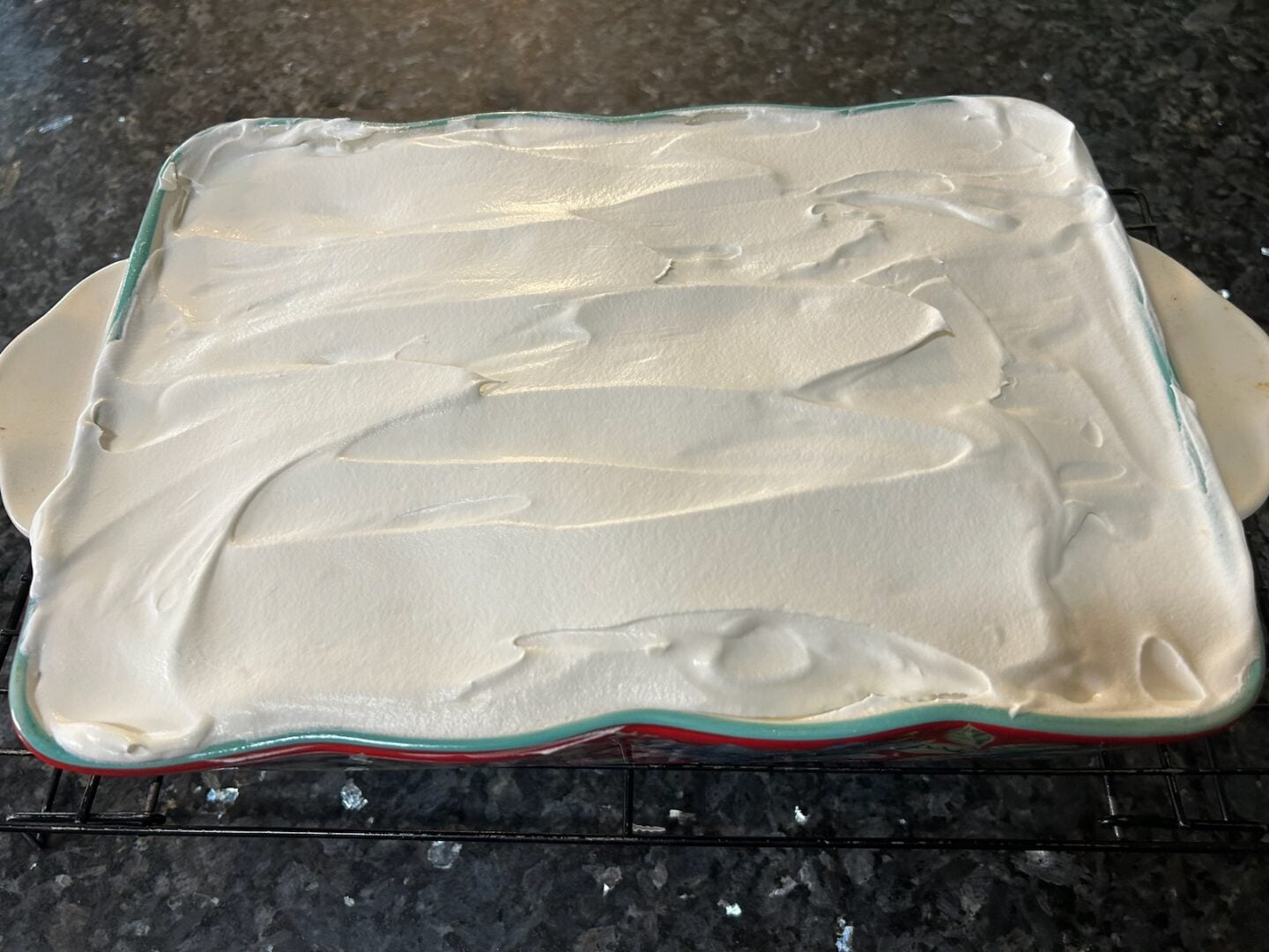 whipped cream spread over cake