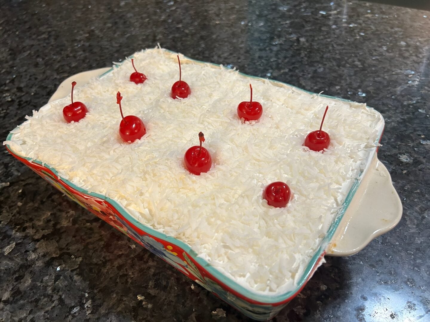 Hawaiian Poke Cake (Hawaiian Cream Cake) decorated with maraschino cherries