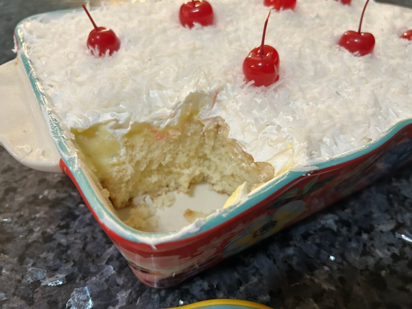 Hawaiian Poke Cake (Hawaiian Cream Cake) with one piece cut out revealing tender crumb and fluffy topping