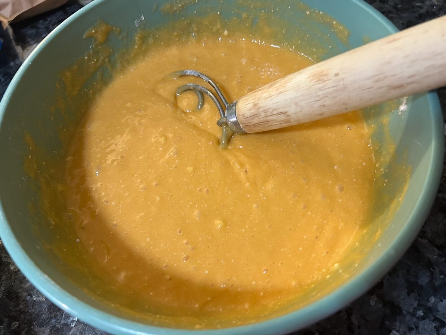 orange cake batter in bowl