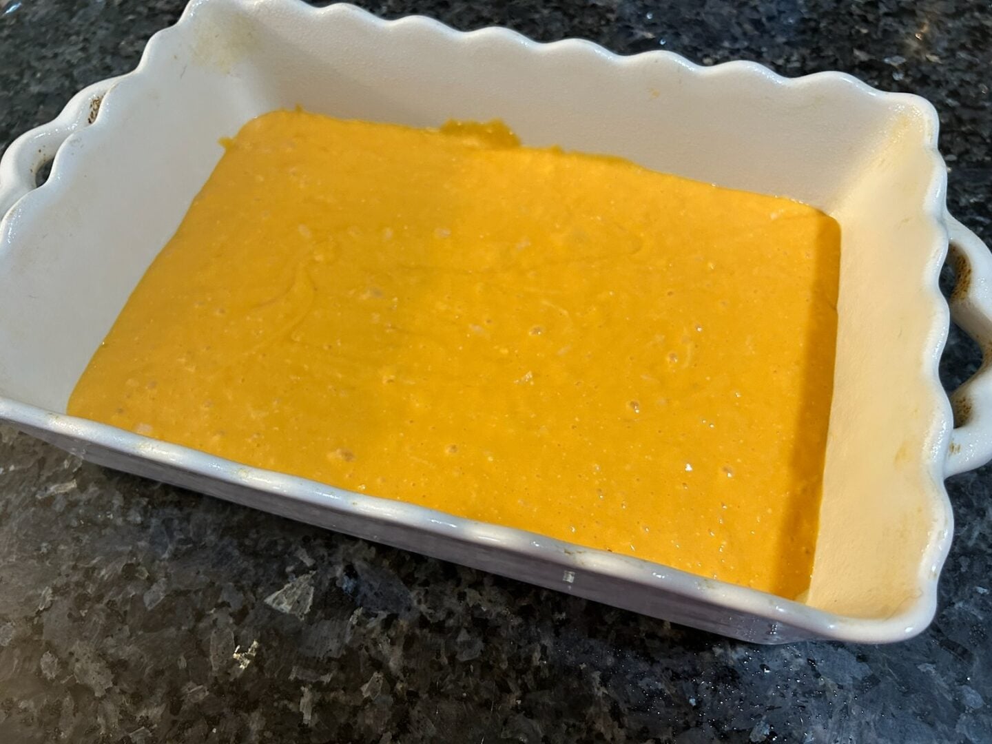 orange cake batter in prepared 9x13-inch baking dish