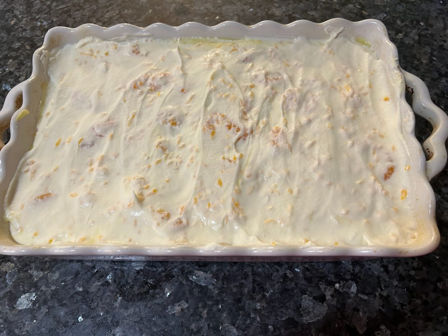 whipped cream on mandarin orange poke cake