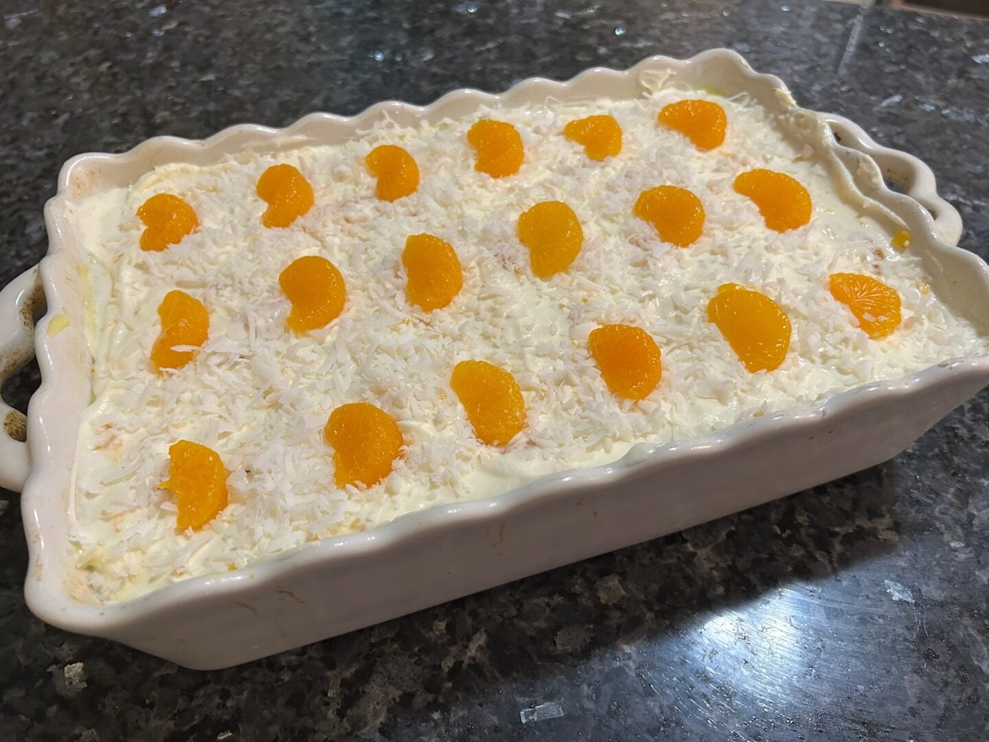 image of mandarin orange poke cake in pan