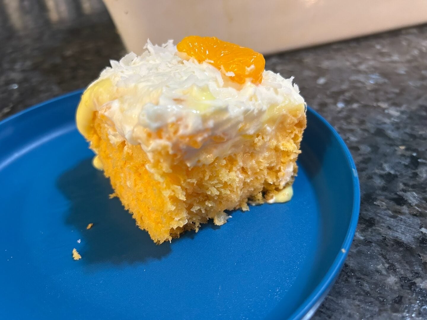 slice of Mandarin Orange Poke cake on plate