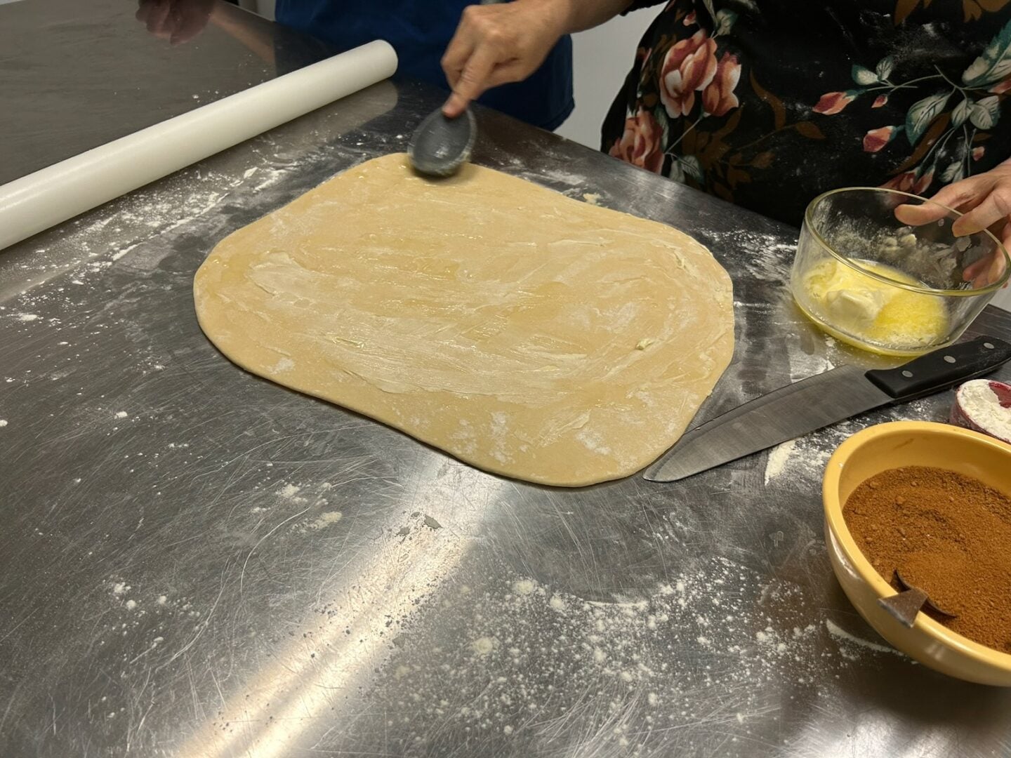 Homemade Honey Buns dough in rectangle with butter added