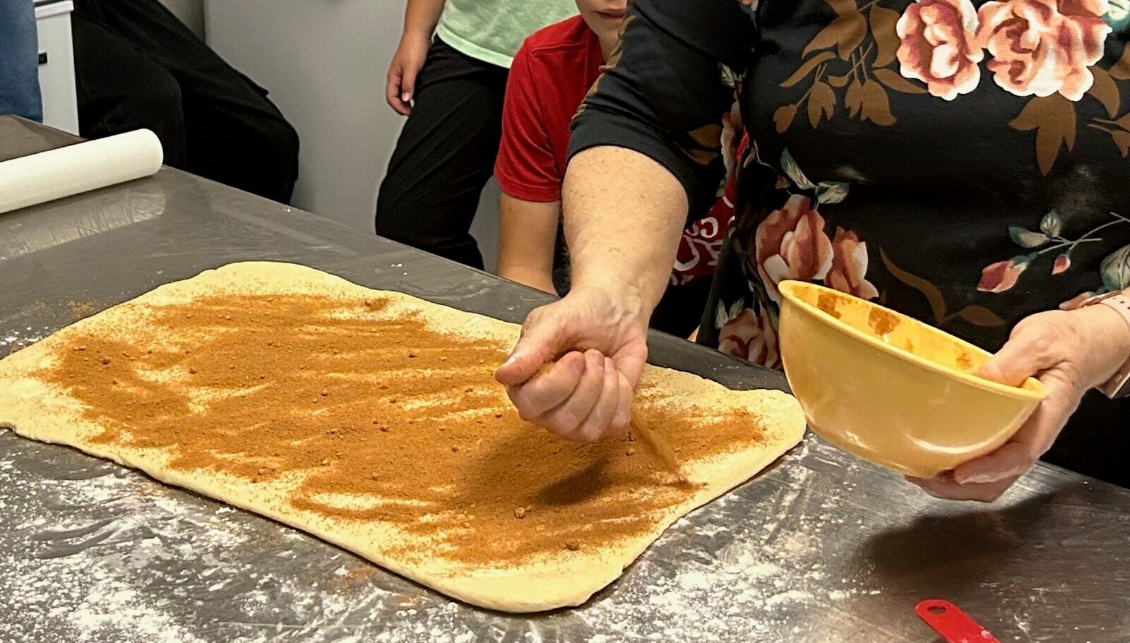 Homemade Honey Buns in rectangle with butter and cinnamon sugar mixture