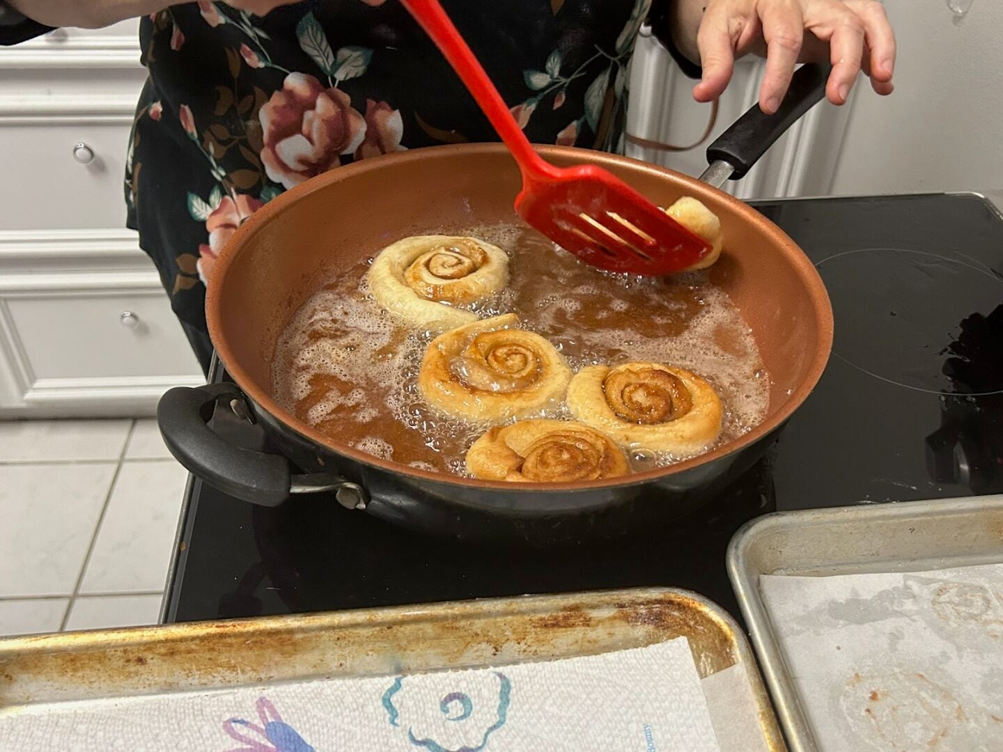 Homemade Honey Buns frying in oil on stove