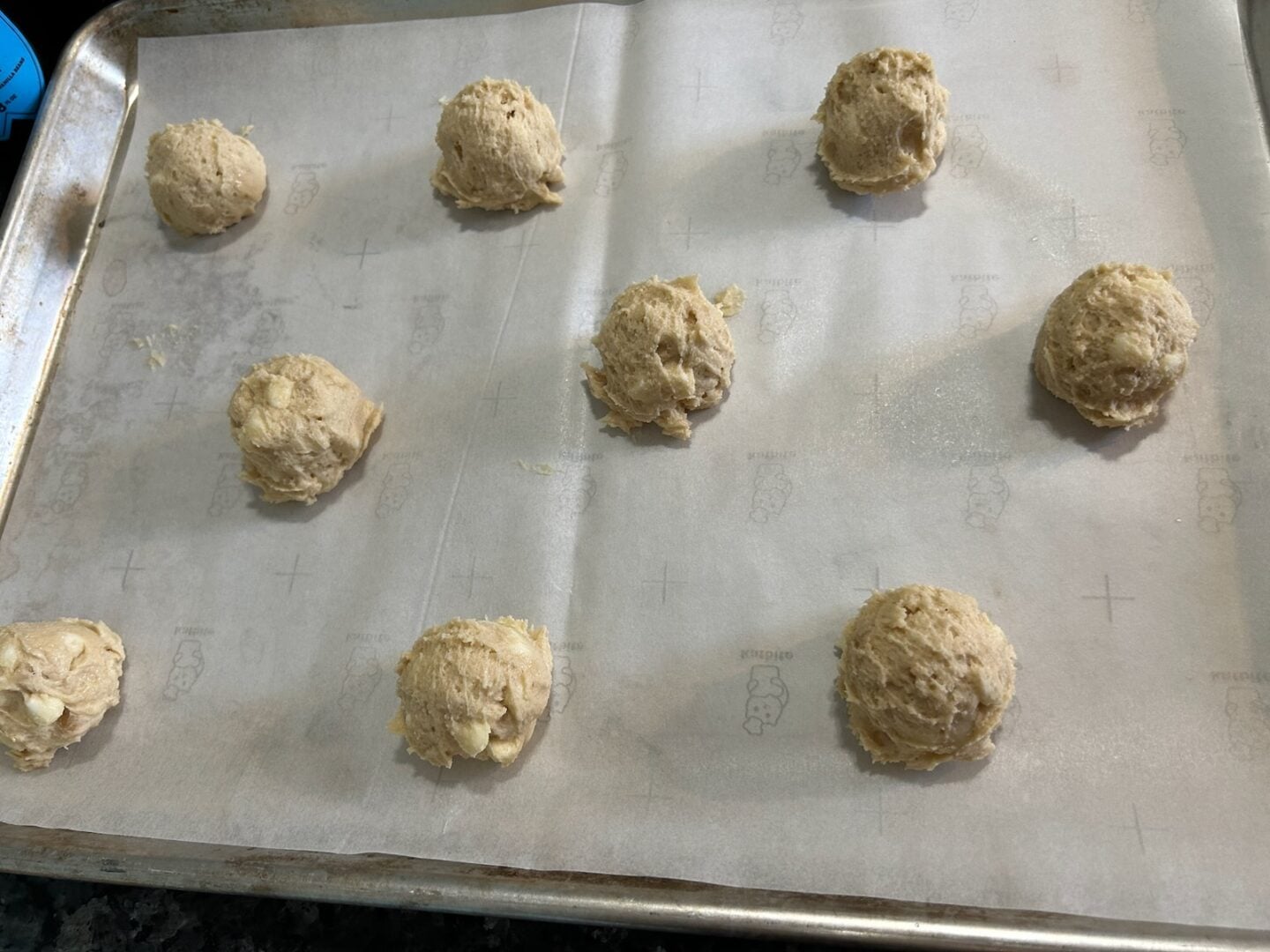cookie dough balls on baking sheet