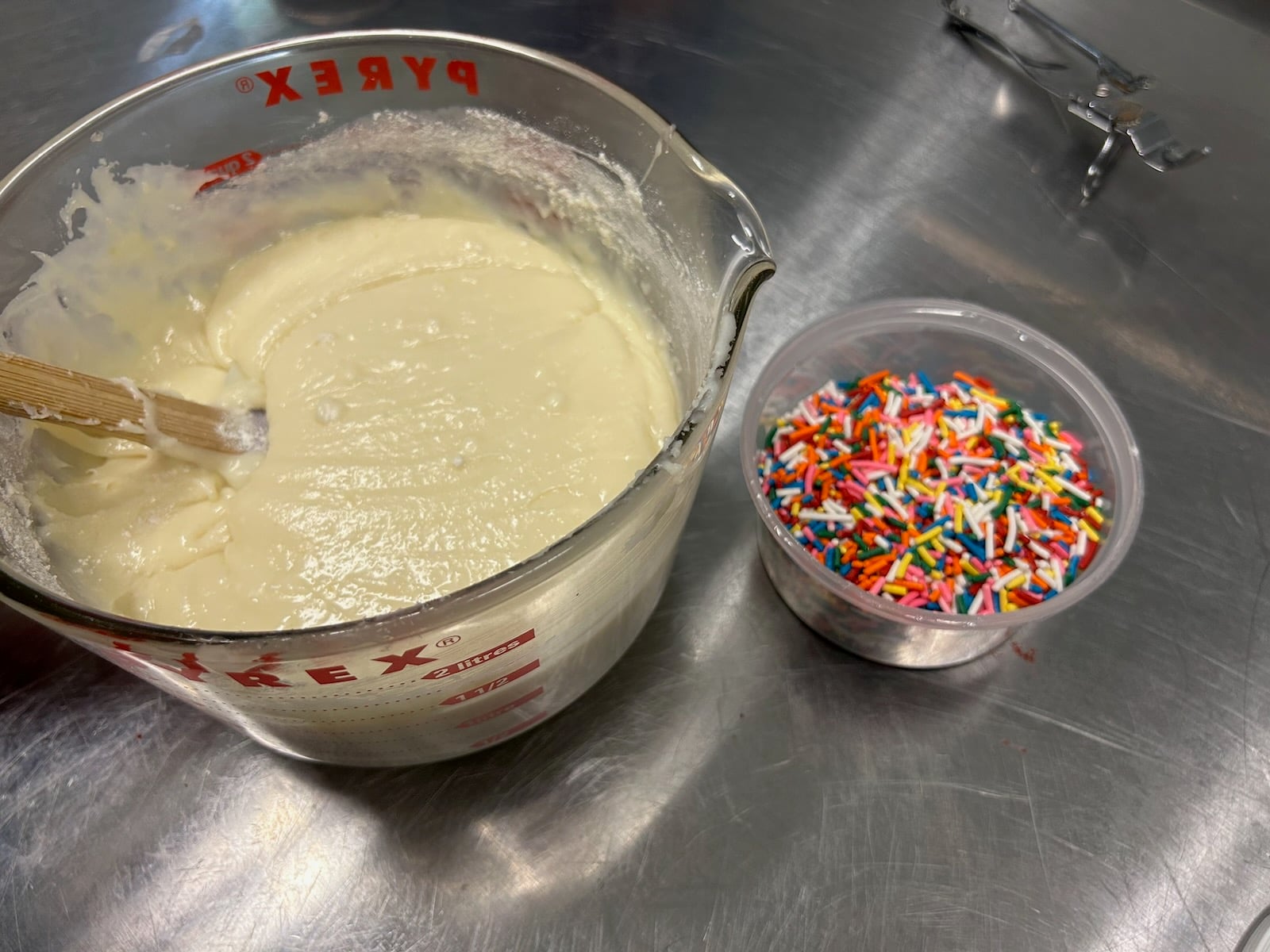 birthday cake fudge batter in bowl, sprinkles nearby