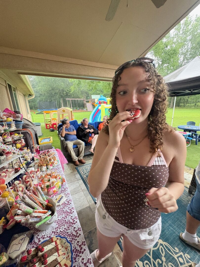 girl eating macaron at party