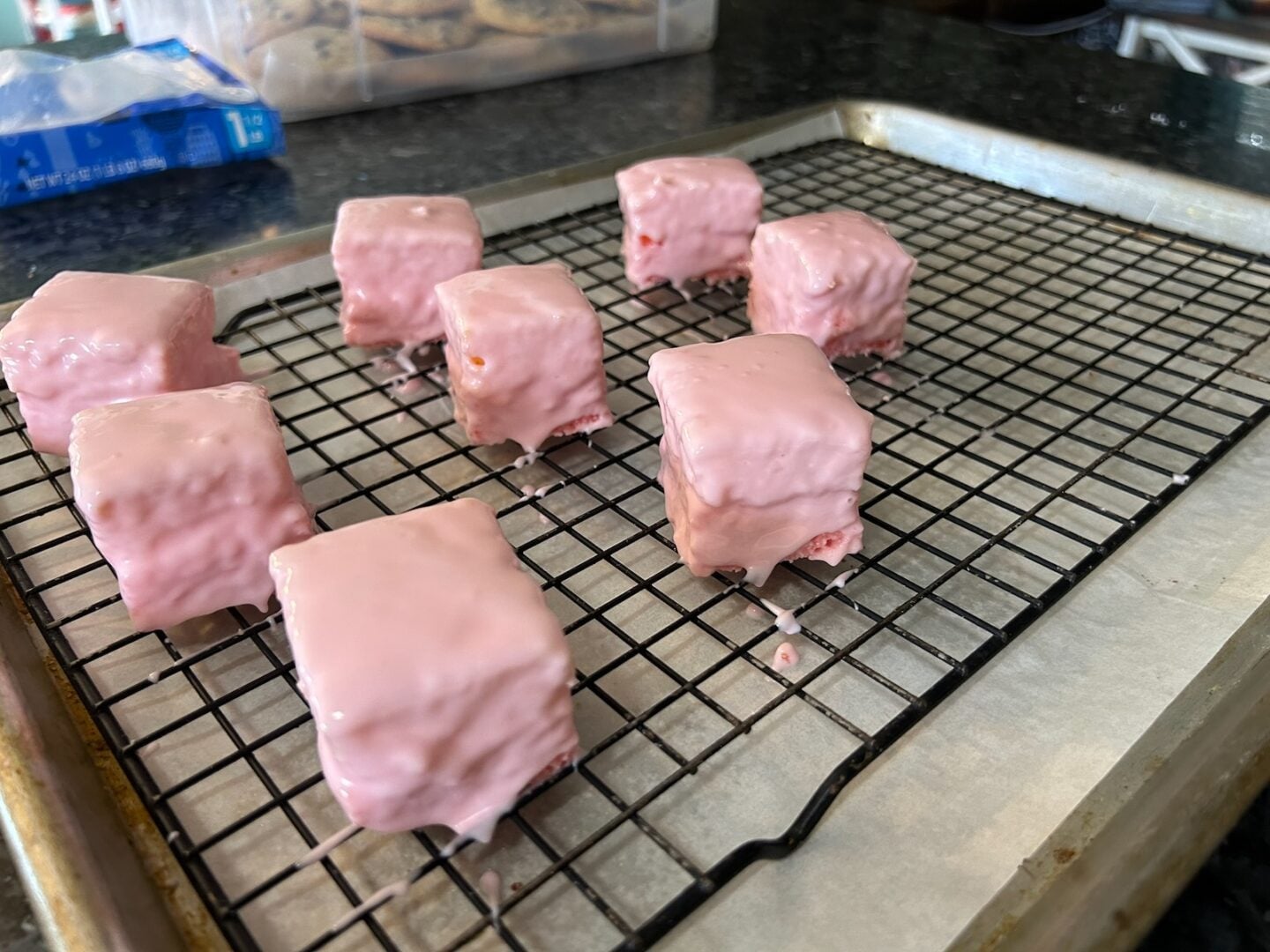 petit fours coated in almond bark and placed on wire rack