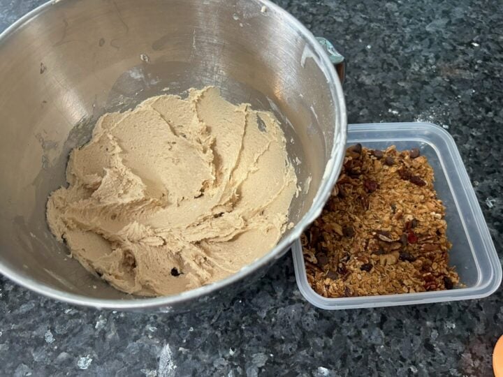granola in bowl next to a bowl of cookie dough