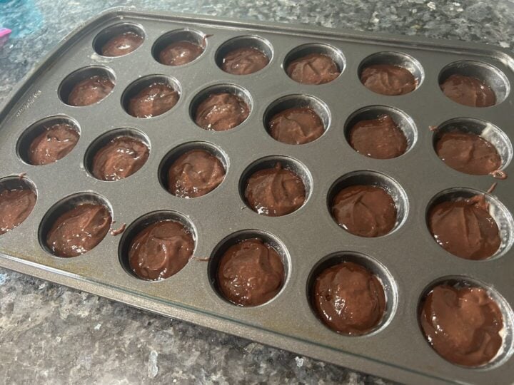 hot cocoa cake batter in mini muffin pan