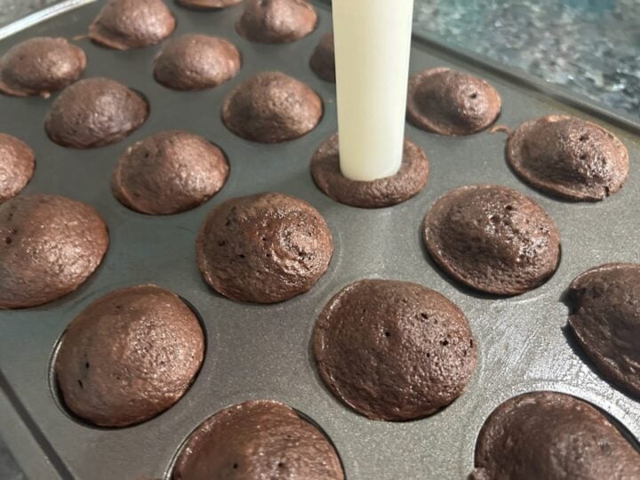 hot cocoa cake bites with tool inserted to create well in cakes